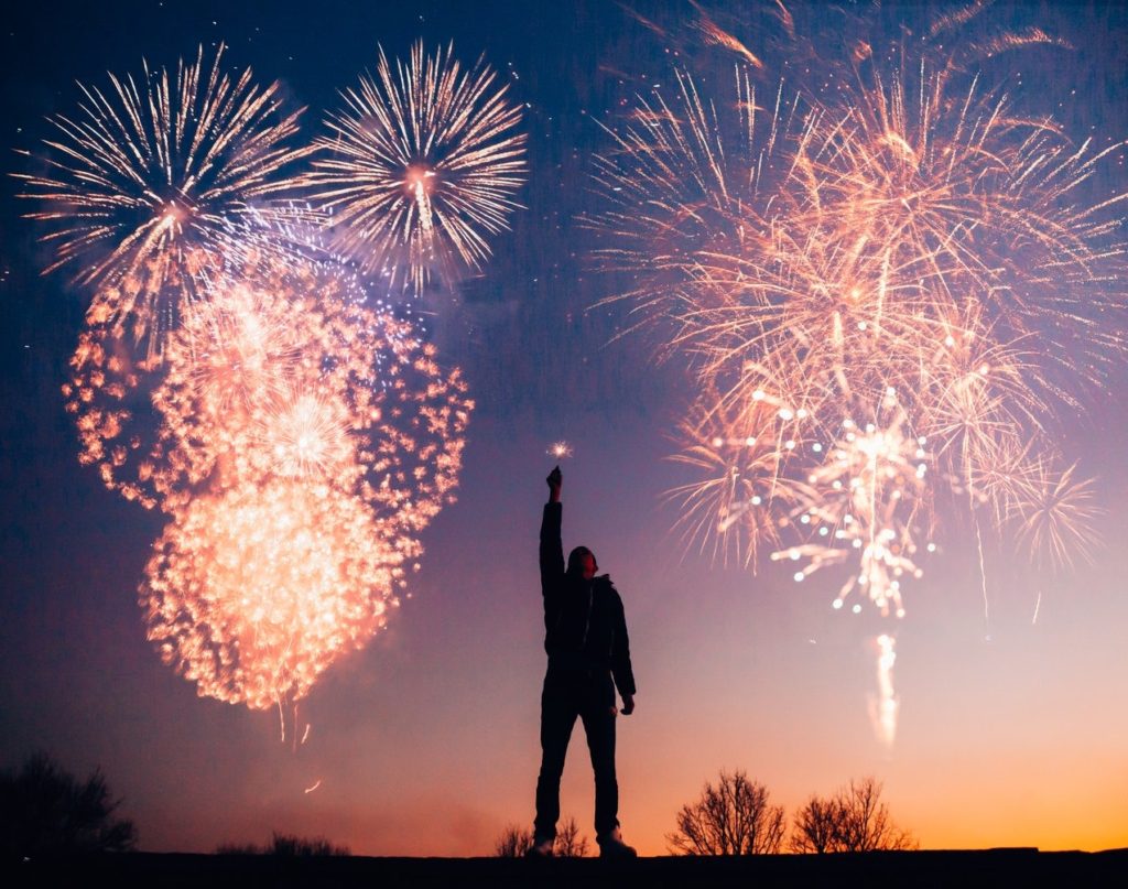 man standing in fireworks